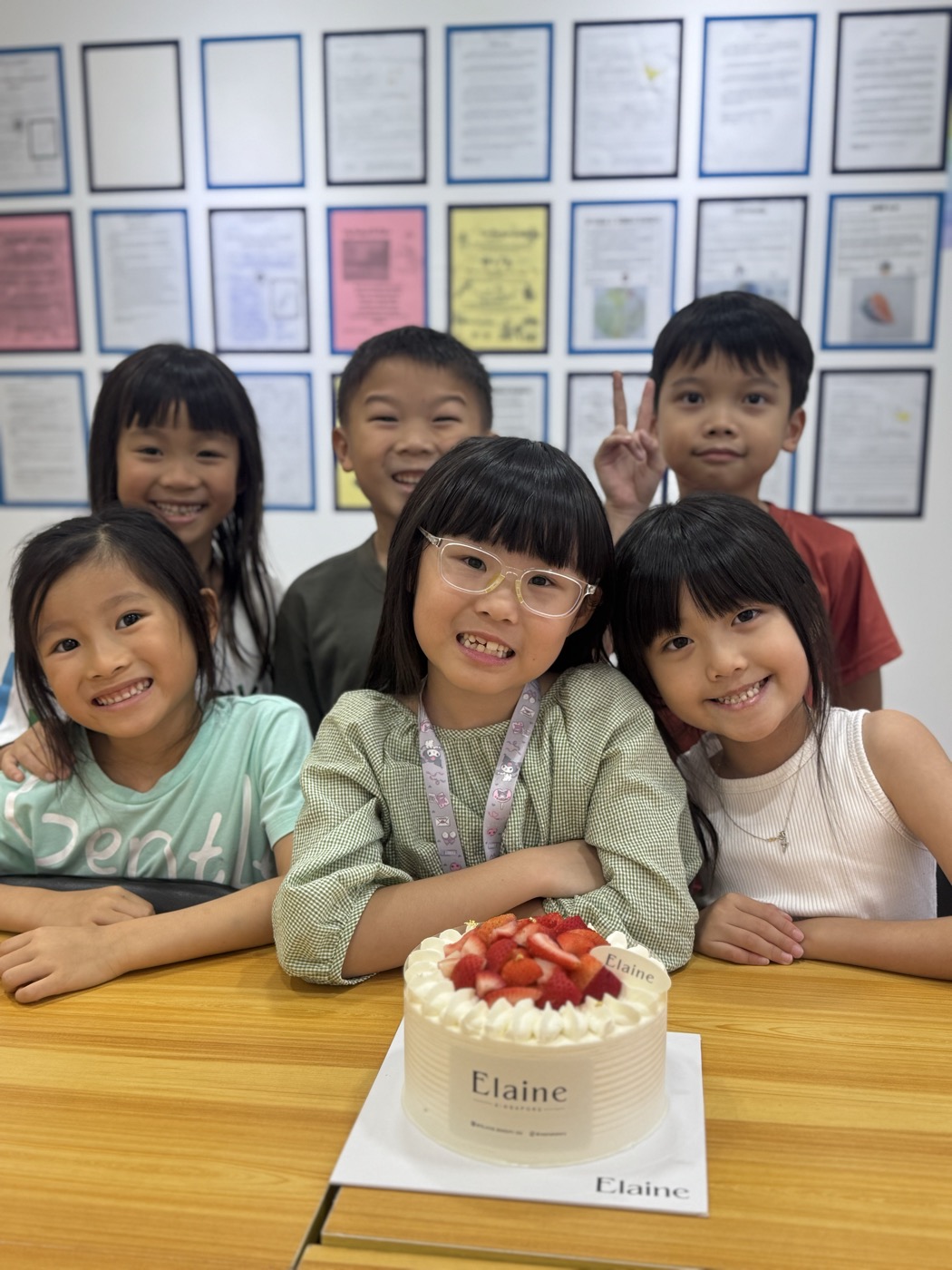 Students celebrating together with a cake at The Lit Adventure