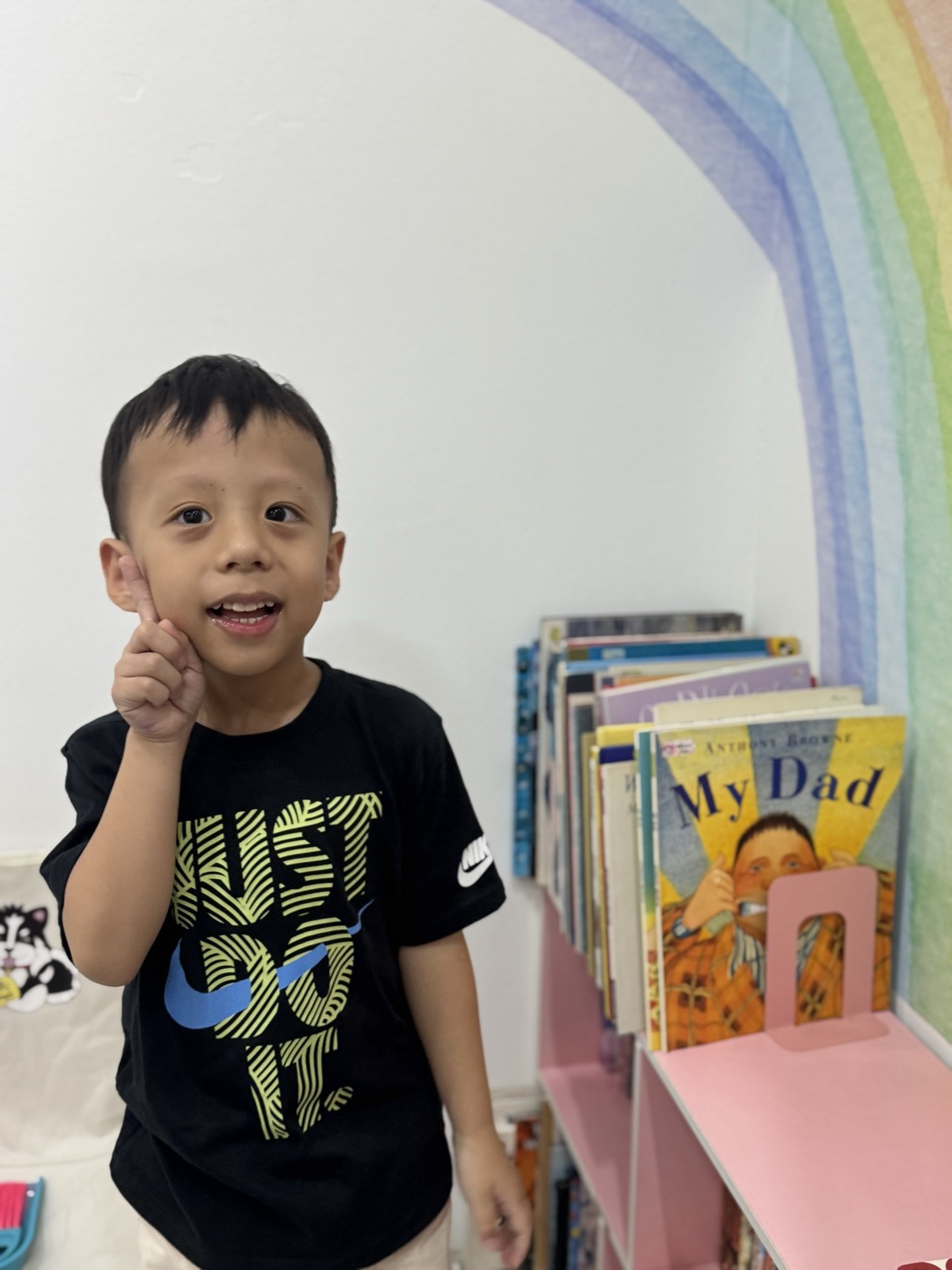 Student smiling and pointing playfully at The Lit Adventure