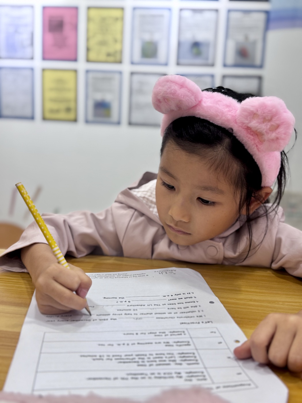 Student focused on her writing during a lesson