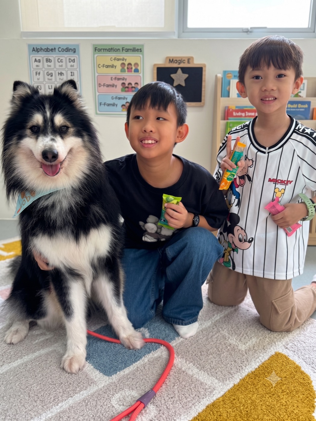 Students with a visiting therapy dog in The Lit Adventure classroom