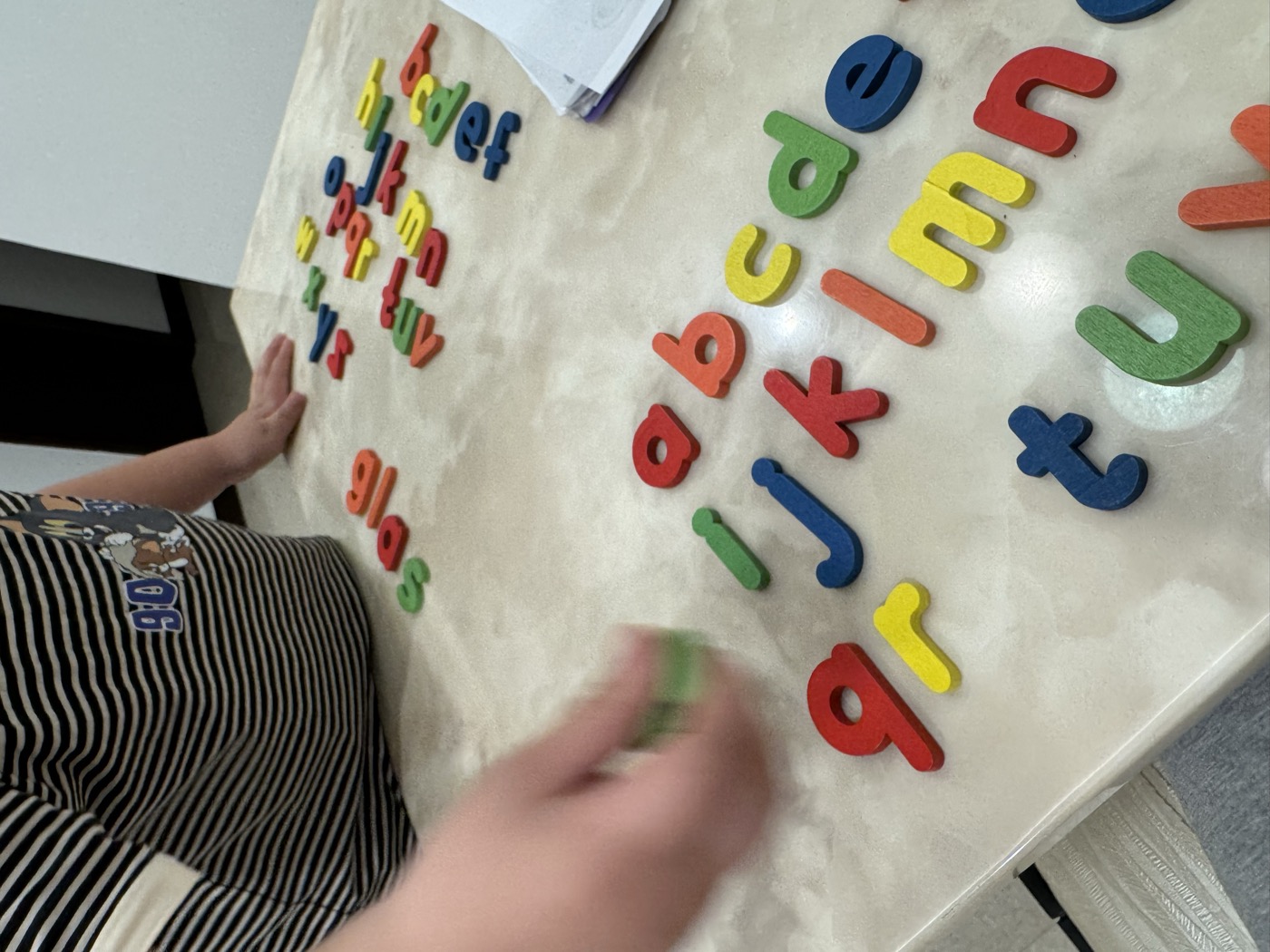 Young student being guided through an alphabet letter activity