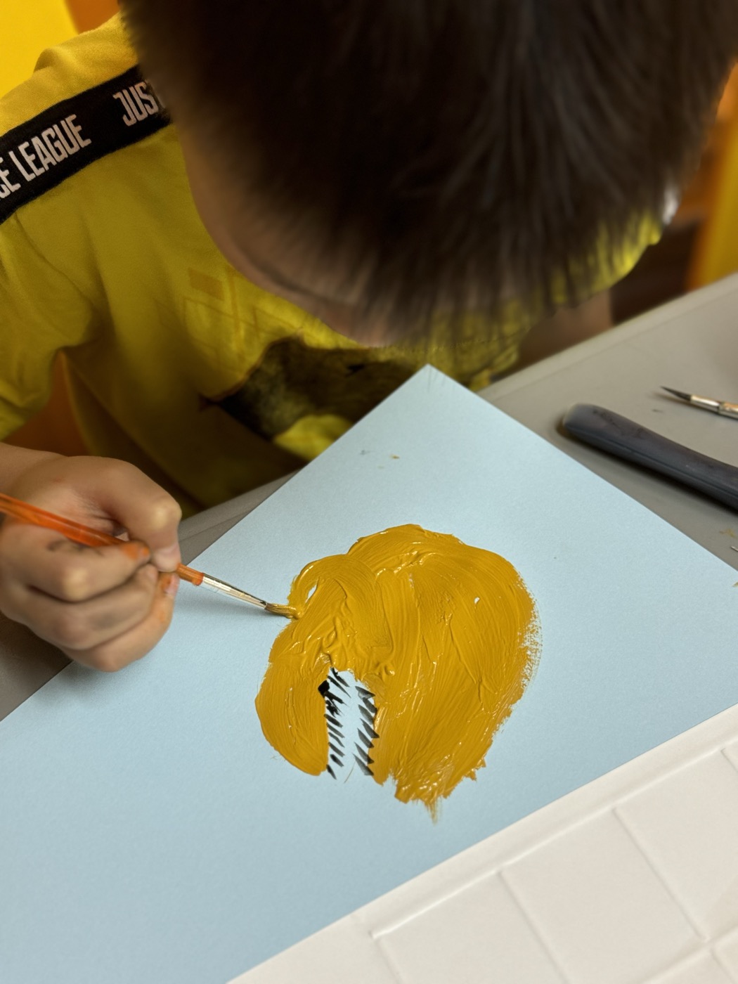 Student painting during an on-site Literary Architect Collab session