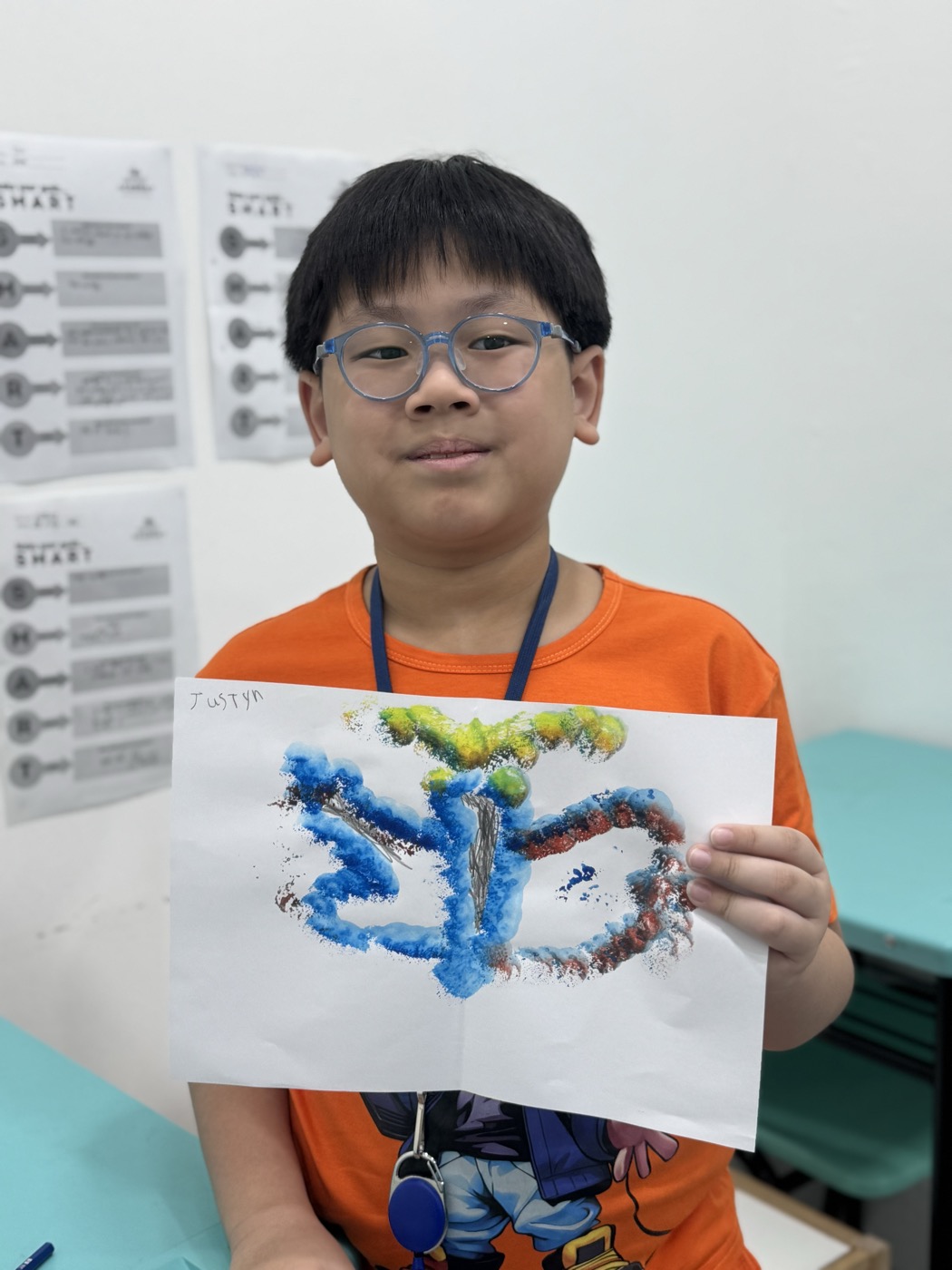 Student presenting his nature-inspired watercolour artwork