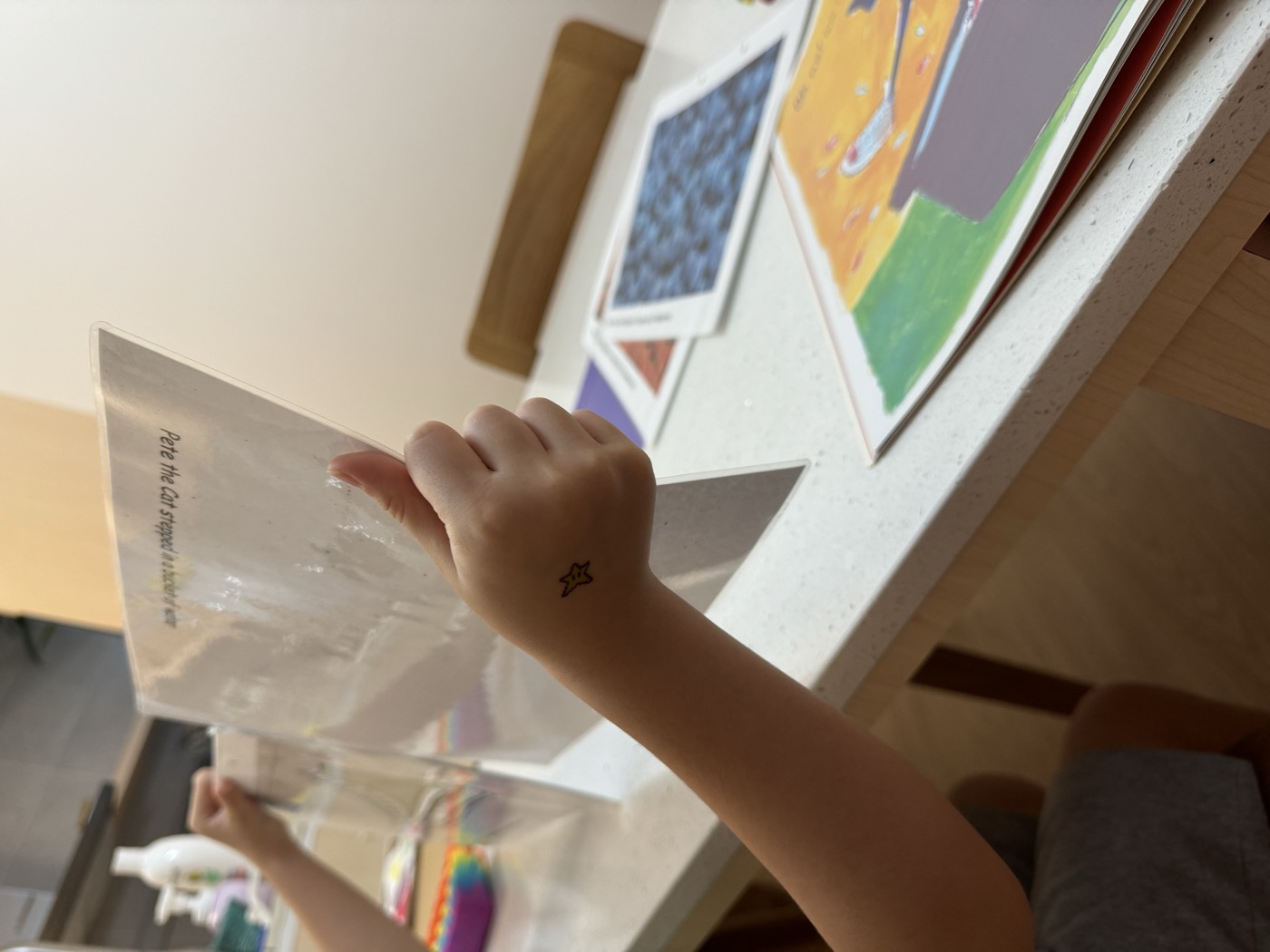 Student reaching for a worksheet during a lesson