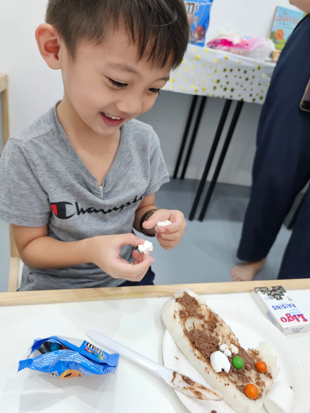 Student smiling during a snack-making activity at The Lit Adventure