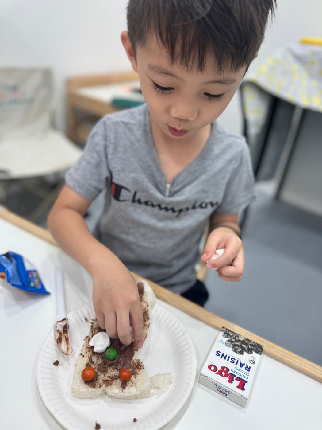 Student smiling during a snack-making activity at The Lit Adventure