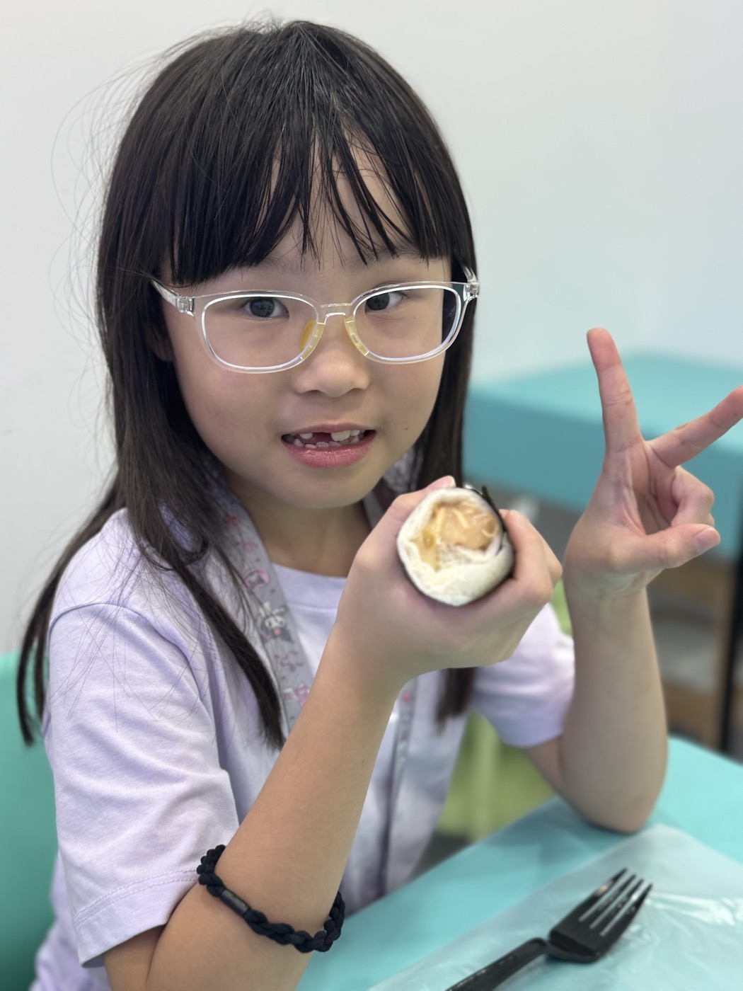 Student smiling during snack break in class