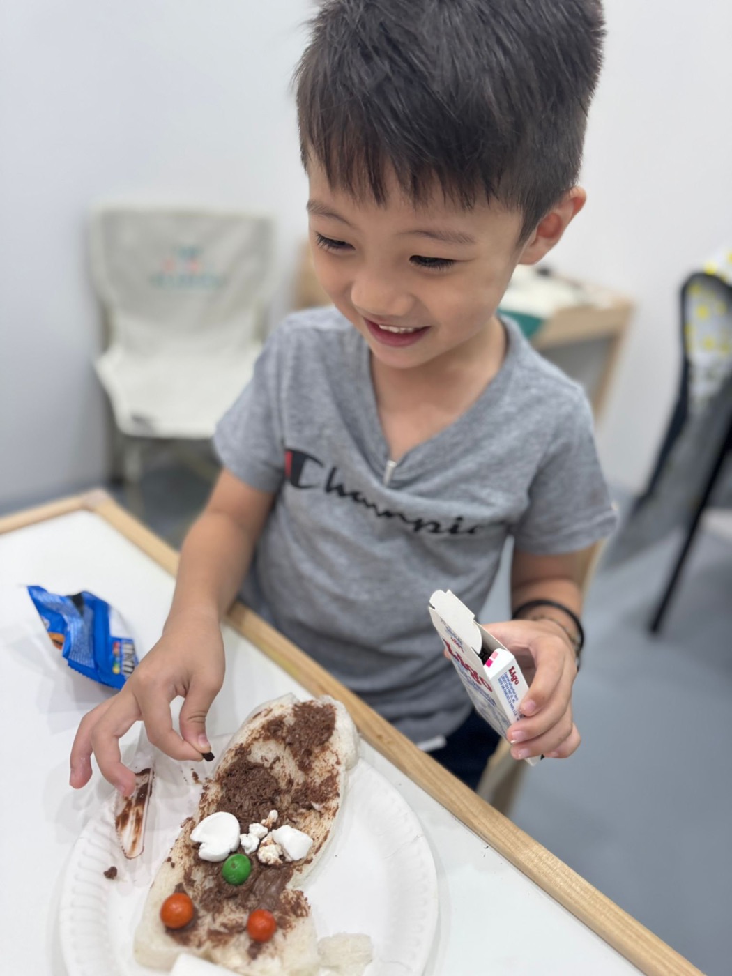 Student decorating a festive snack at a holiday workshop