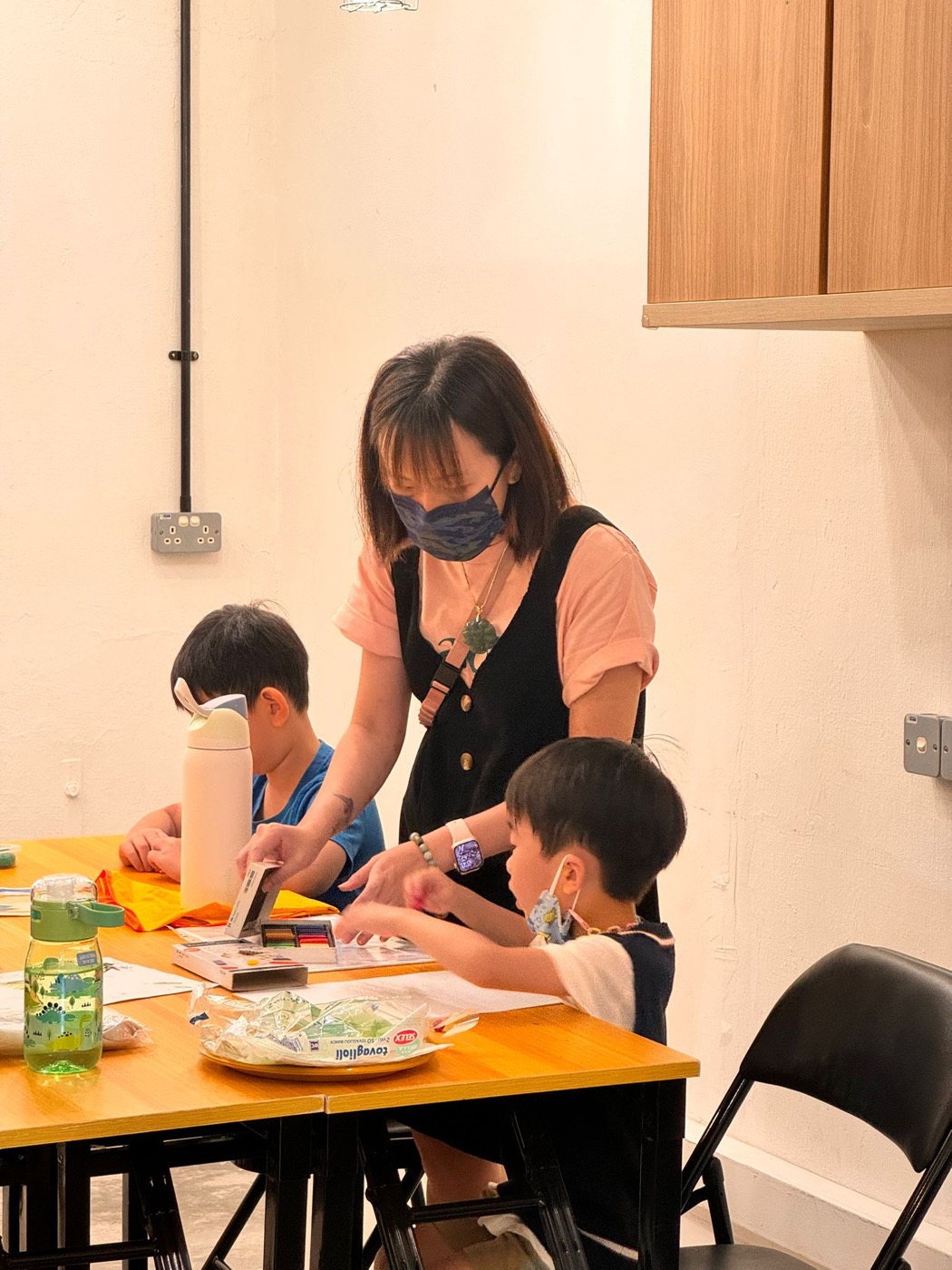 A Lit Adventure teacher helping students with a craft activity